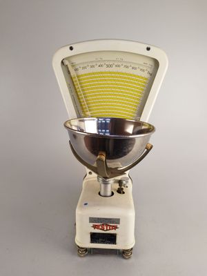 a scale with a bowl on top of it on a table