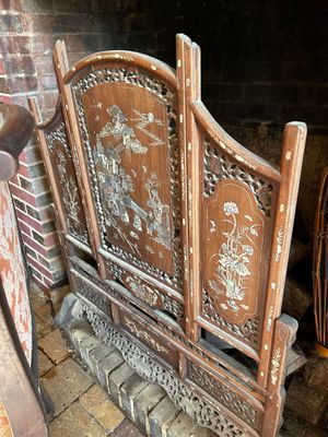 a wooden bed with a carved headboard and foot board