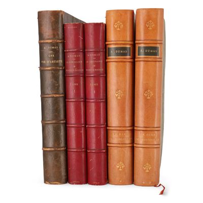 plusieurs vieux livres sont empilés sur une surface blanche