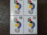 four postage stamps with different designs on them sitting on a table