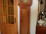 a grandfather clock sitting in the corner of a room