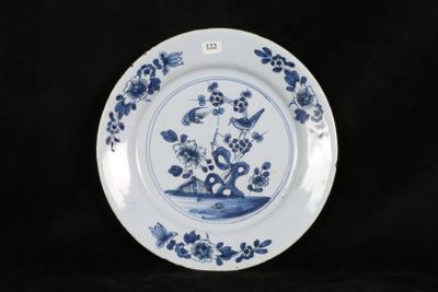 a blue and white plate with flowers and birds on it