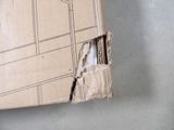 a cardboard box with a hole in it on the floor