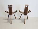 two wooden chairs sitting next to each other in a room