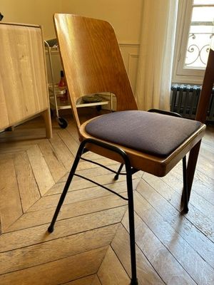 a chair that is sitting in a room with wood floors