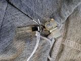 a close up picture of a cell phone attached to a sweater