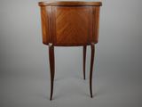 a small wooden table with a drawer on top of it
