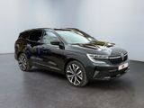 a black bmw x5 suv parked in a showroom