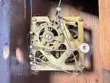 a clock that is in a wooden box with wires