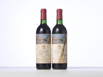 two bottles of red wine sitting on top of a table