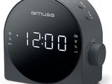 a black alarm clock sitting on top of a white surface