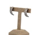 a close up of a pair of earrings on a stand