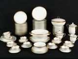 a lot of white and gold dishes and cups