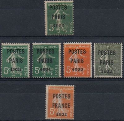 four different postages of different colors and sizes on a black background