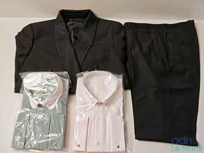 a suit, shirt, tie, and pants laid out on a table