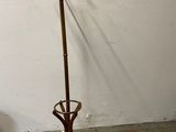 a coat stand with a coat rack in the corner of a room