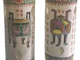 pair of chinese vases with oriental designs on them against a white background