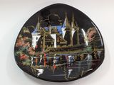 a black plate with a picture of a castle on it