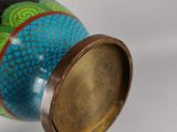 a vase with a lid that has a dragon design on it
