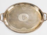 a large silver tray with handles on a white surface