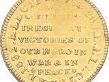 a close up of a gold coin with writing on it