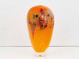 a glass vase with a painting on it sitting on a table
