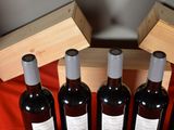 several bottles of wine are lined up in a row on a table