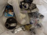 a bag of assorted items sitting on a bed