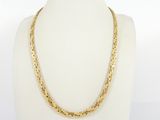 a close up of a gold necklace on a mannequin mannequin