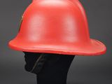 red fireman ' s helmet on a black mannequin head