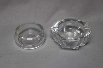 a glass ashtray and a glass ashtray on a table