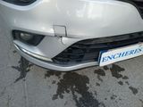 the front end of a white car with a license plate on it