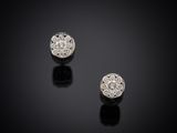 a pair of diamond stud earrings on a black surface