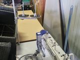 a sewing machine that is sitting on a table in a room