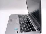 a close up of a laptop on a white surface