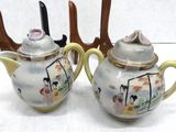 two teapots that are sitting on a table