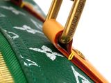 a close up of a green purse with a gold handle