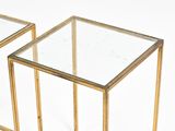 pair of brass and glass side tables with a clear glass top