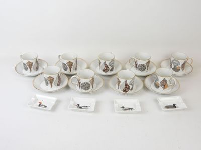 a lot of cups and saucers sitting on a table