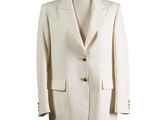 the suit is white and has a gold button on the lapel