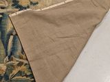a rug on the floor with a piece of cloth on top of it