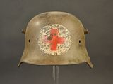 an old military helmet with a red cross painted on it