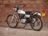 a motorcycle that is parked in front of a brick wall