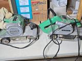 two power tools sitting on a table in a room