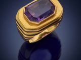 a gold ring with an amethorate stone in the center
