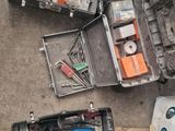 an overhead view of a tool case filled with tools on the ground