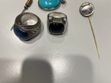deux bagues, une épingle, une broche et une bague posées sur une table
