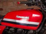 a close up of a red motorcycle parked in a garage