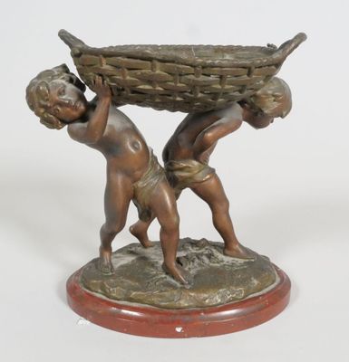 bronze statue of two children carrying a basket on top of a wooden base