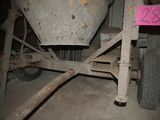 a cement mixer sitting in a garage next to a sign